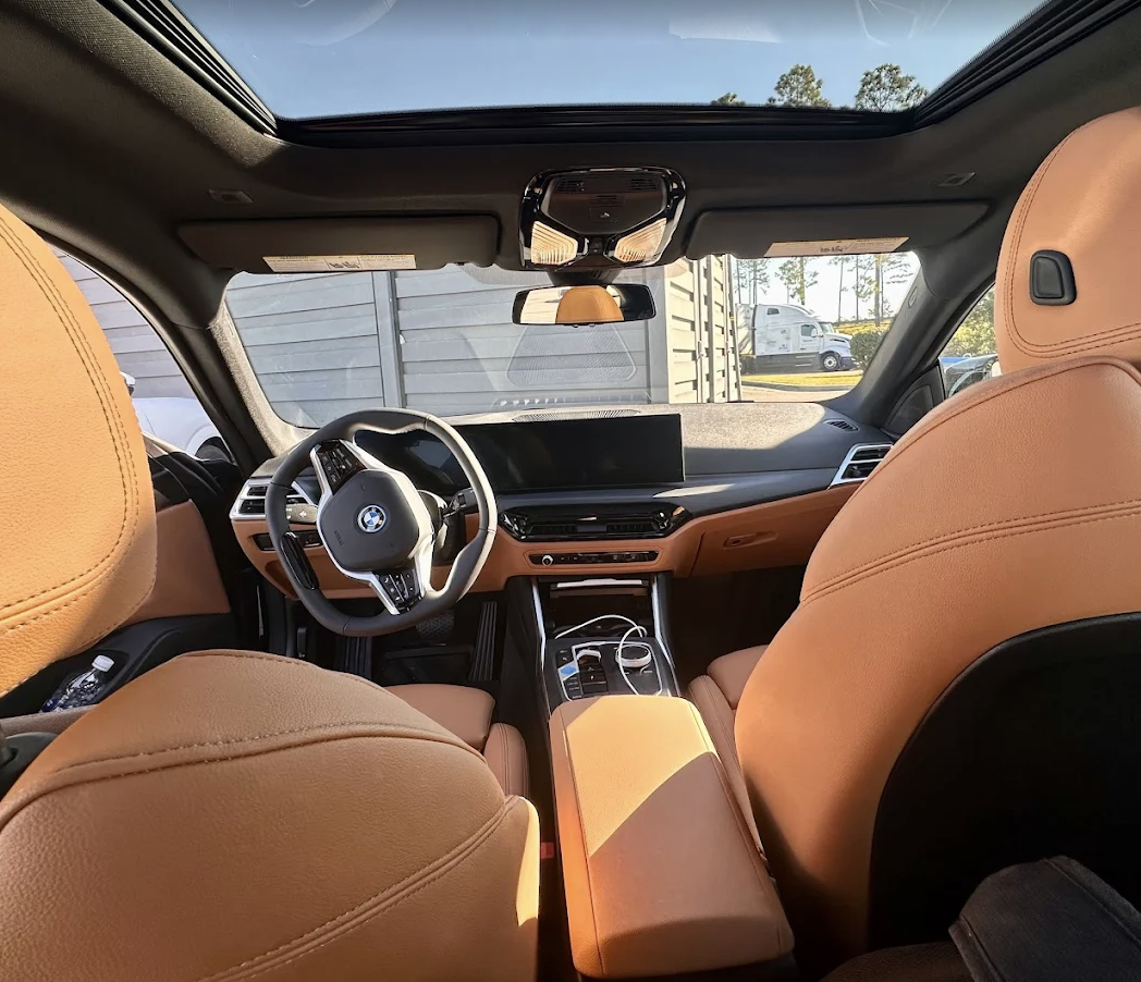 Interior of a new car with cognac leather seats — the kind of purchase The Auto Lease Ninjas makes transparent.